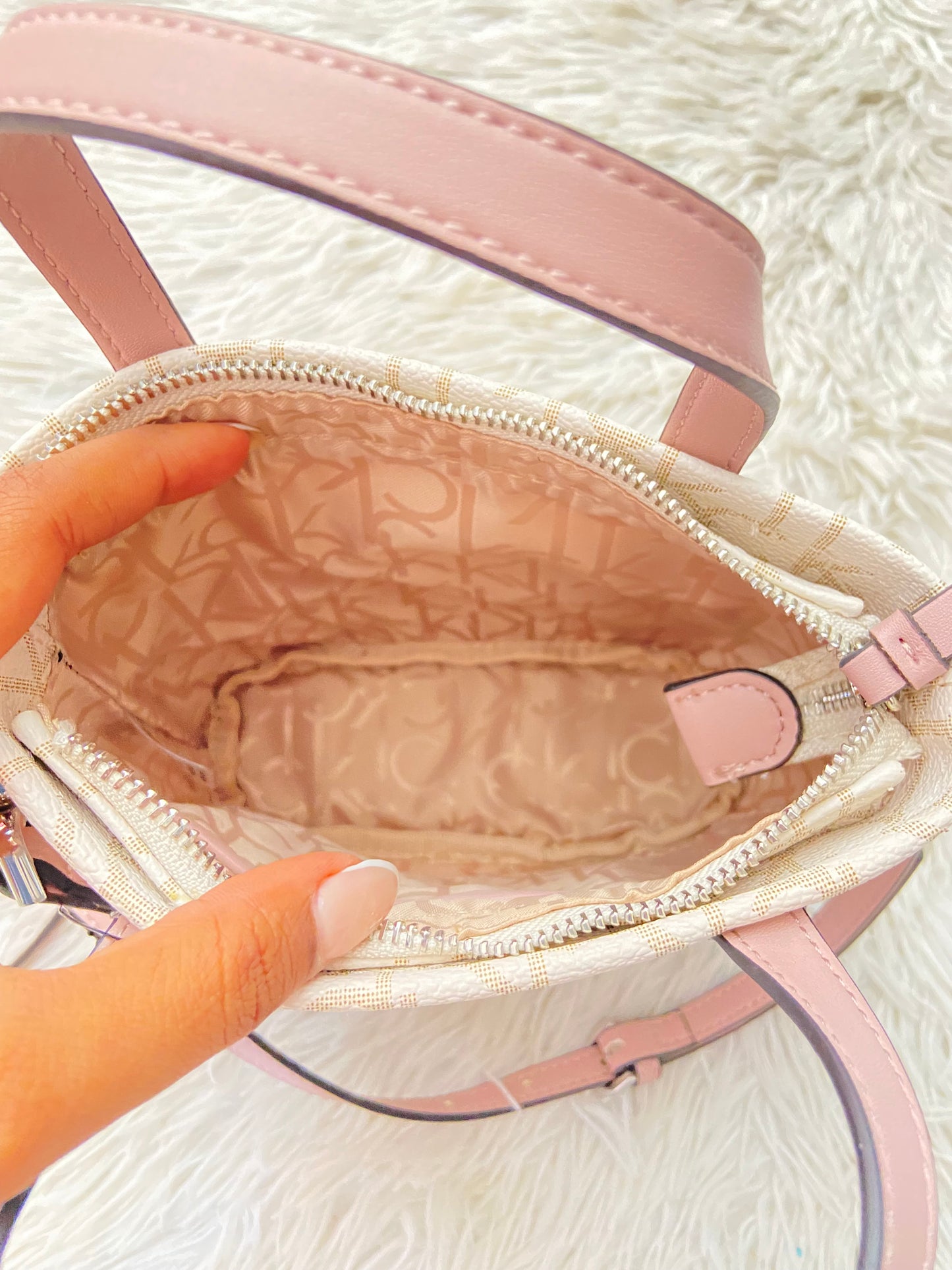 Cartera/ Crossbody CALVIN KLEIN original crema con rosado y estampado de letras CK y placa CK en rosado.