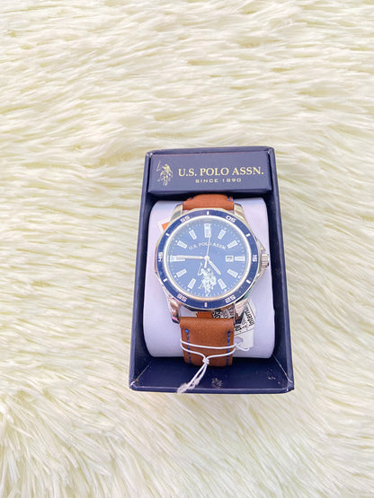 Reloj U.S POLO original, marron con costura en hilo azul, y fondo azul con plateado.