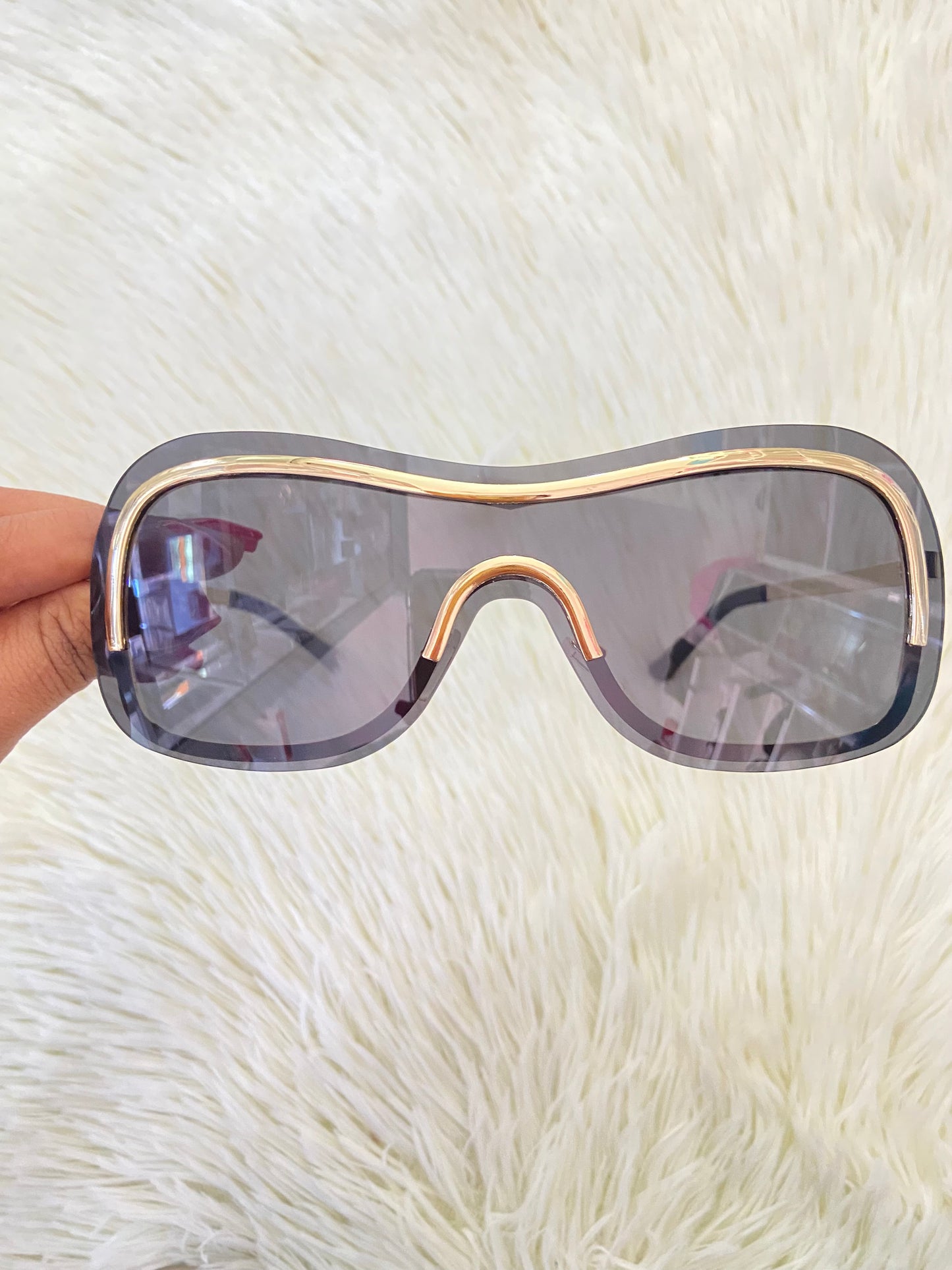 Lentes, negros, grandes curvos, con línea dorada al rededor y montura en  dorado.