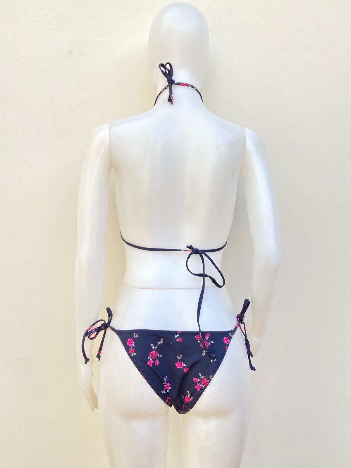 Biquini, negro con estampado de flores y encaje en color blanco.