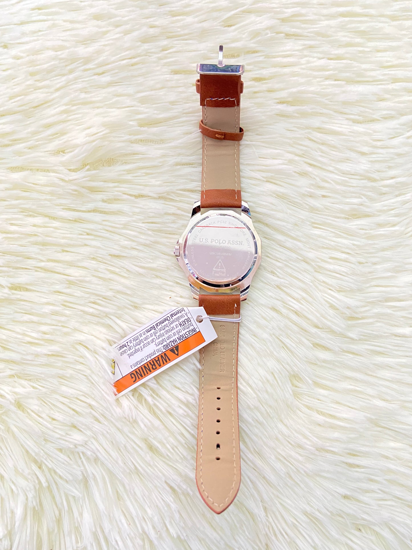 Reloj U.S POLO original, marron con costura en hilo azul, y fondo azul con plateado.