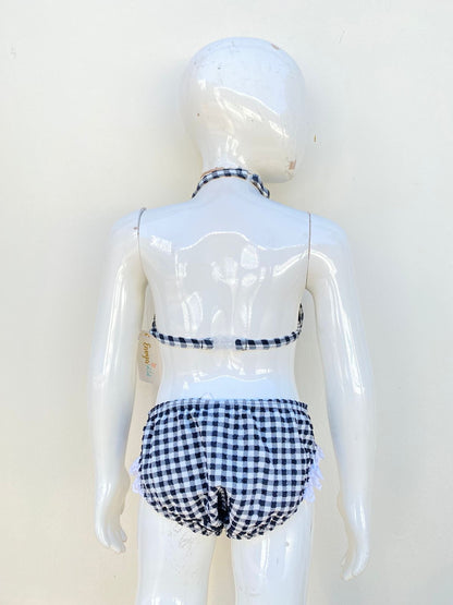 Biquini Traje de baño niñas Envya kids original, negro con cuadros en blanco y moño en blanco.