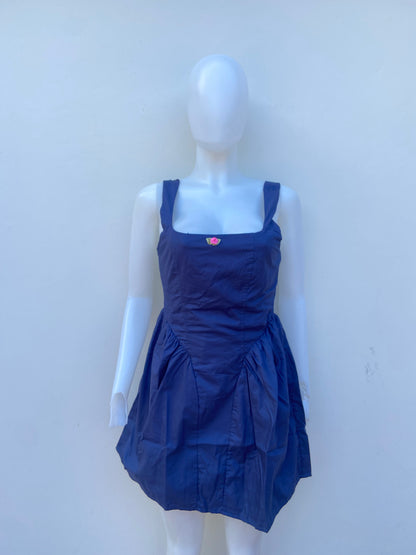 Vestido, algodón orgánico en azul marino ( NAVY) con flor rosada en frente.