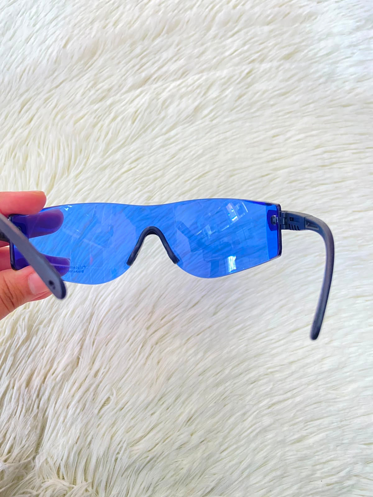 Lentes, sin montura con micas en color azul y patillas negras.