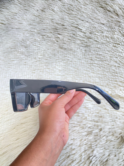 Lentes con protección UV 100-400 para proteger tu visión. Negros con montura cuadrada plana y cristales negros claros