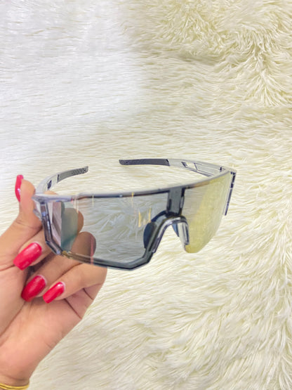 Lentes, gris con micas que cambian de color a dorado cromados, 100 % Polycarbonate más protección UV.