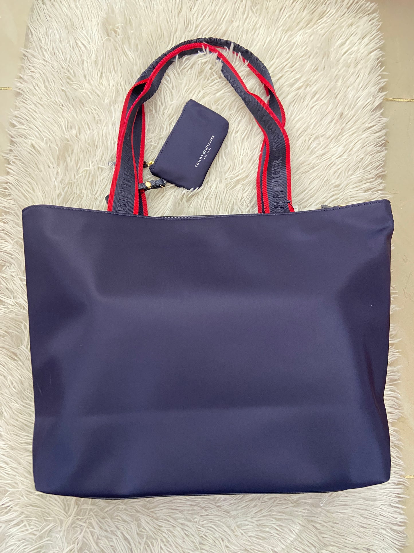 Cartera Tommy Hilfiger original azul marino con rojo y letras TOMMY HILFIGER en blanco.