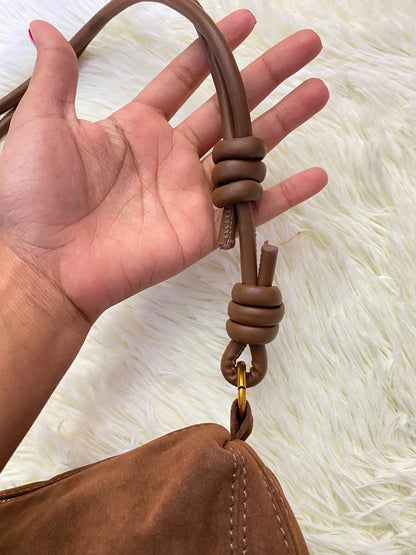 Cartera, marron en terciopelo y nudos en la manga.
