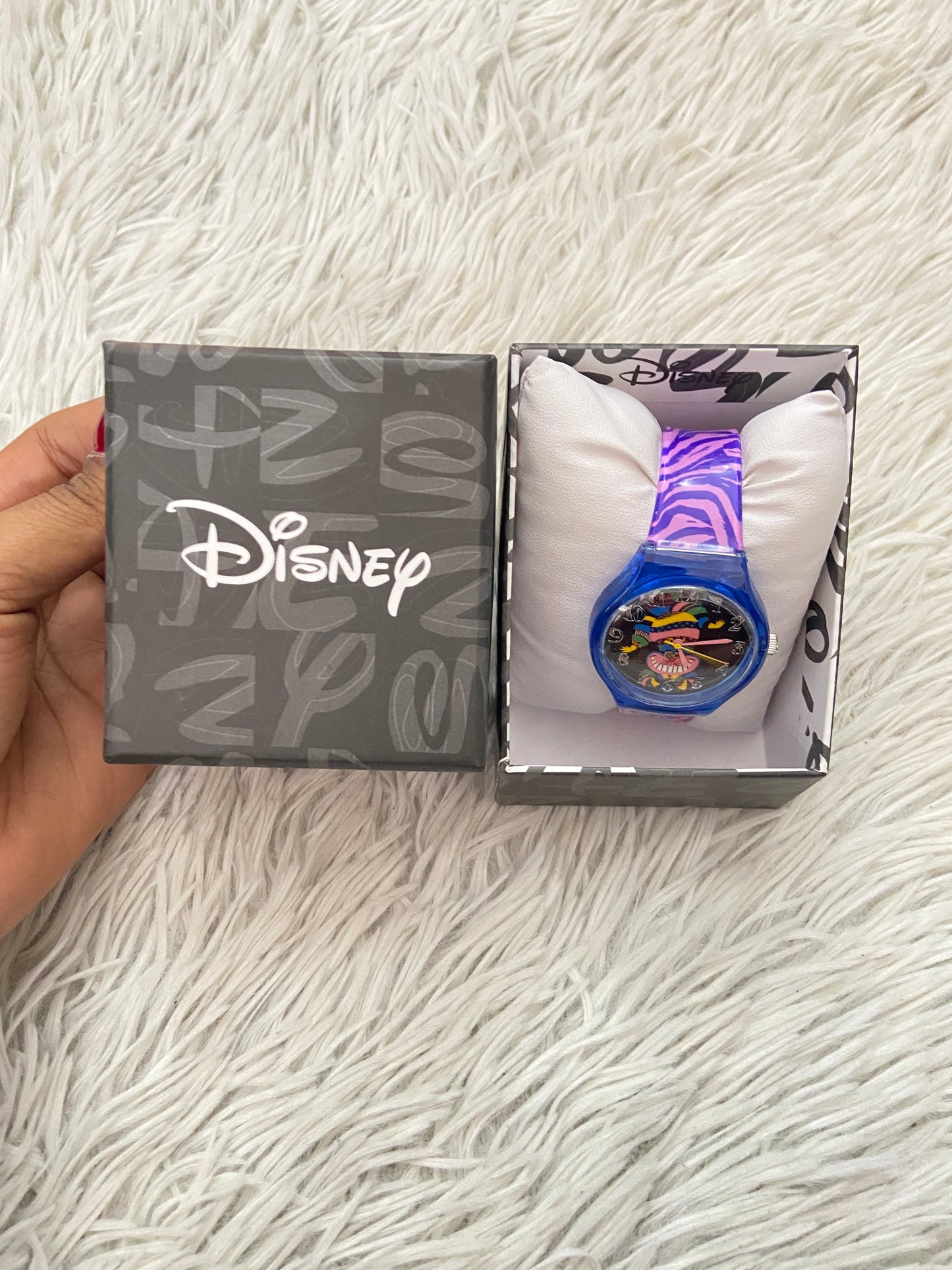 Reloj Disney original morado con azul marino y caricatura de un gato de fondo.