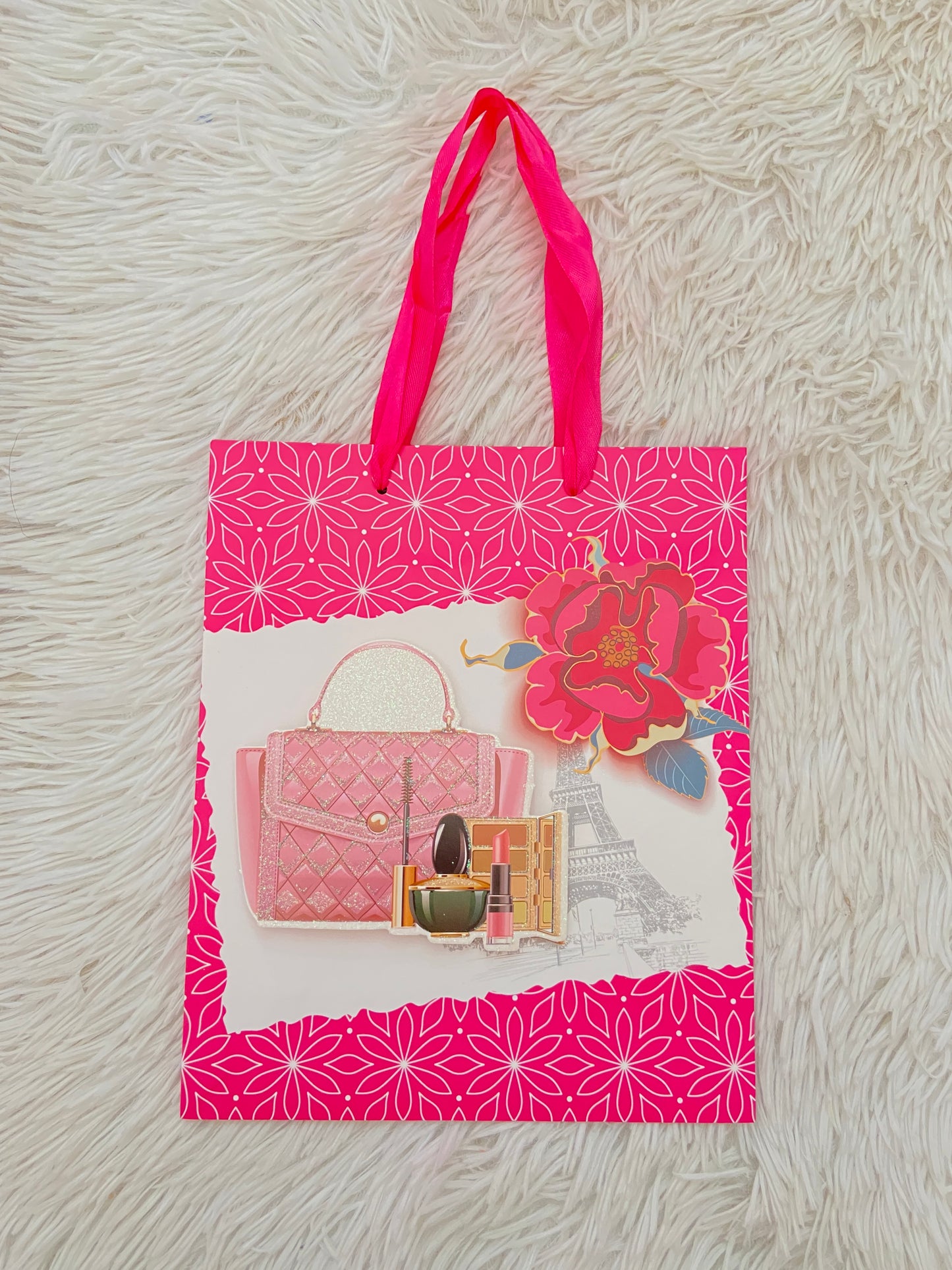 Shopping rosado con estampado de cartera y maquillaje.