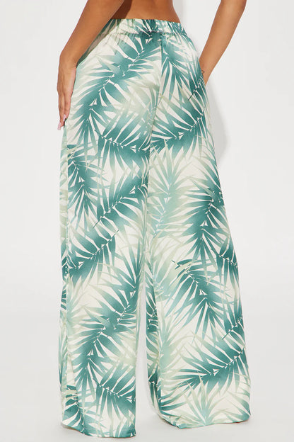 Pantalón,palazzo crema con estampado de palmeras verde.