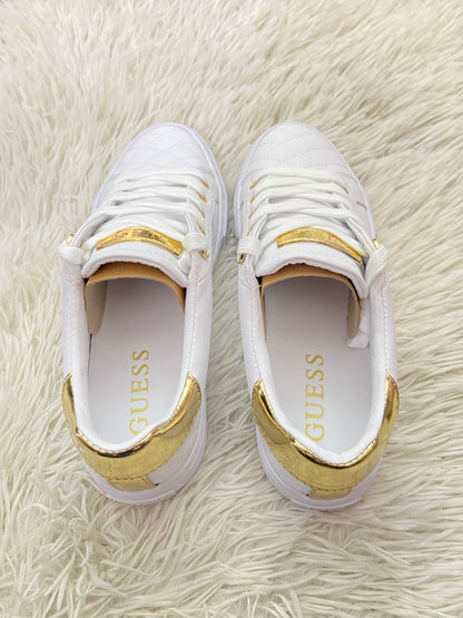 Tenis GUESS original blanco con detalles en color dorado y placa GUESS en dorado.