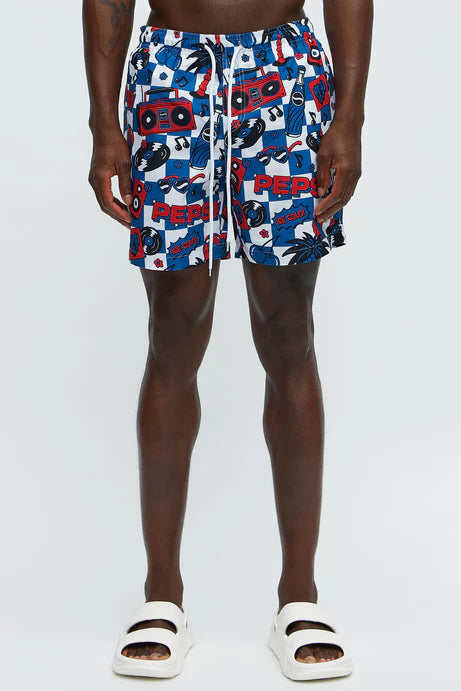 Bañador/Baggy, azul con estampado de discos, palmeras y flores en color blanco y rojo.