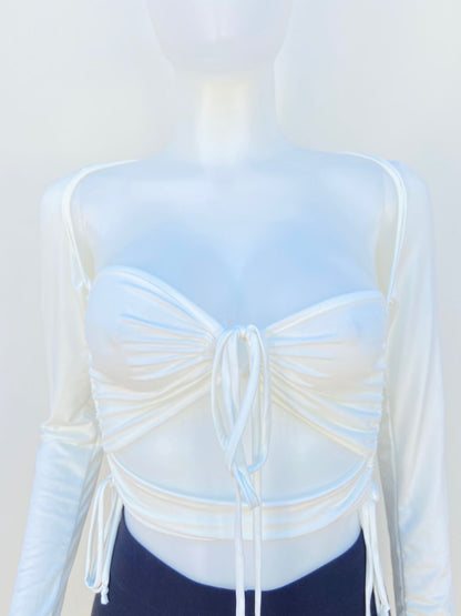 Top blanco manga larga con diseño ajustable en él centro y en los lados.