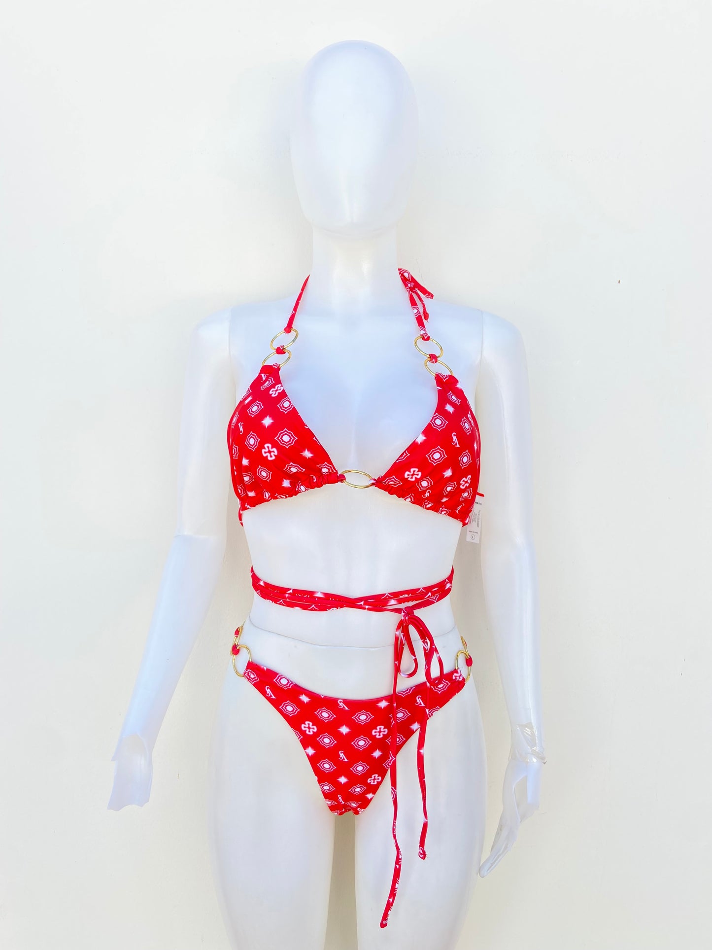 Biquini, rojo con estampado en color blanco y Cadena dorada en los lados.