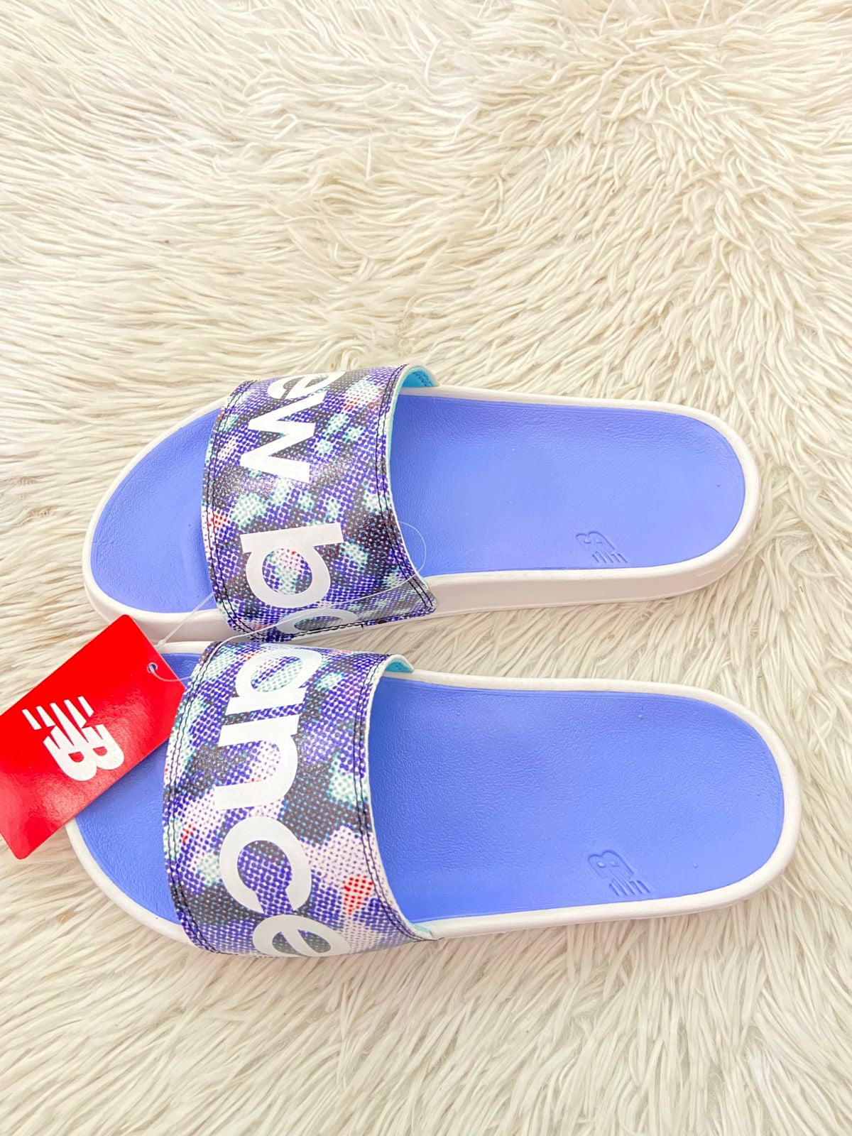 Sandalias NEW BALANCE original, azul claro con blanco y letras de la marca en frente.