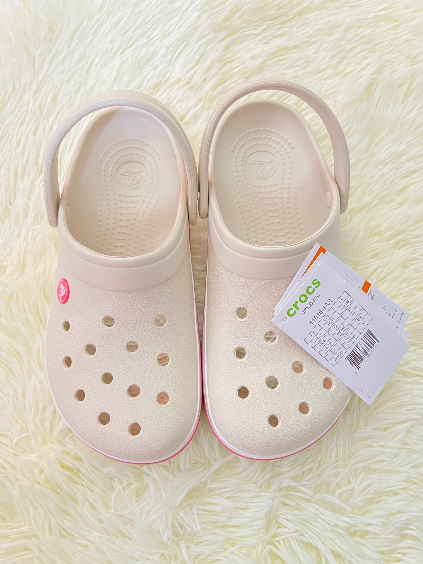 Sandalias CROCS original, crema con líneas rosadas y blancas.