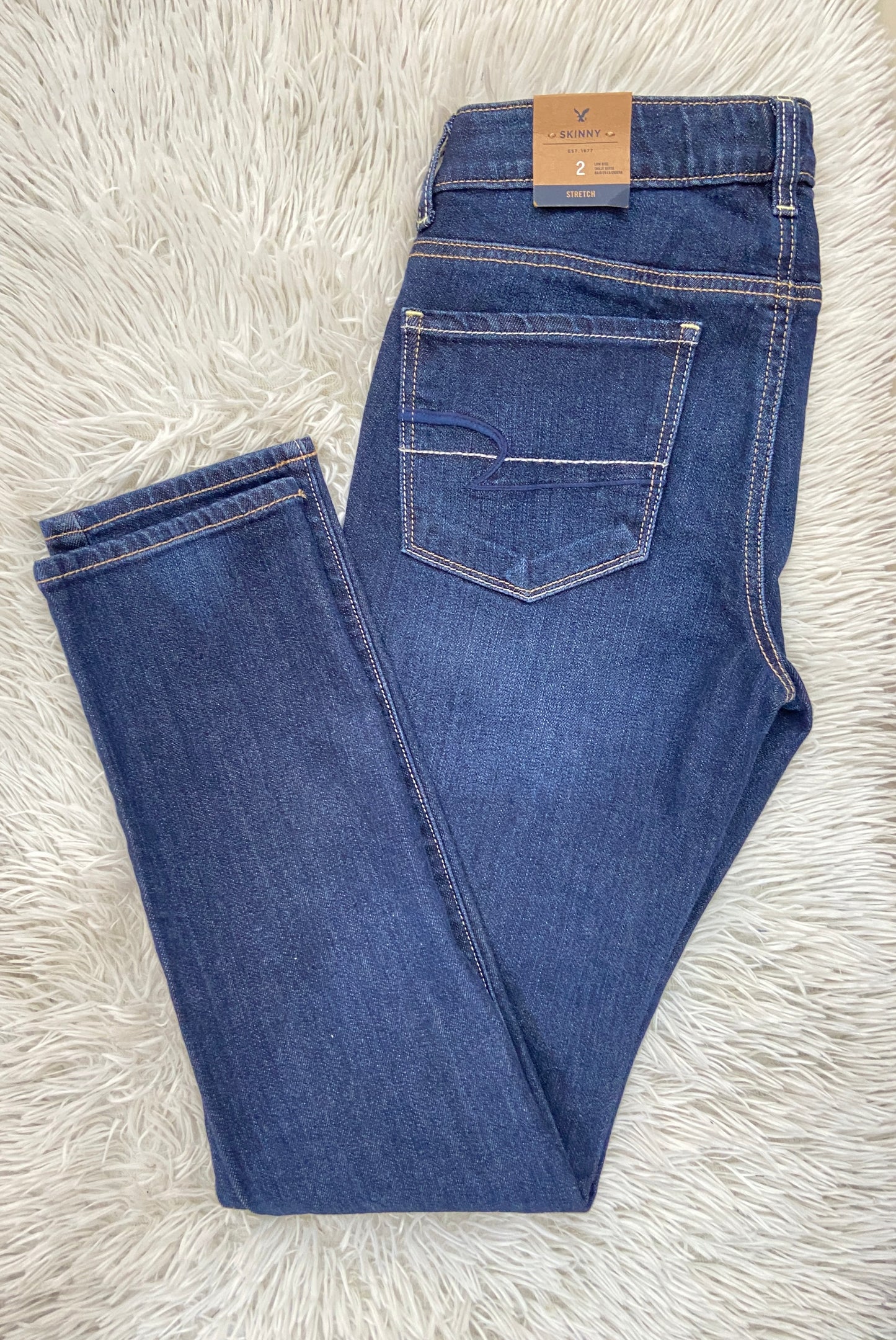 Pantalón Jean American Eagle original azul súper oscuro liso, SKINNY LOW RISE STRECH.