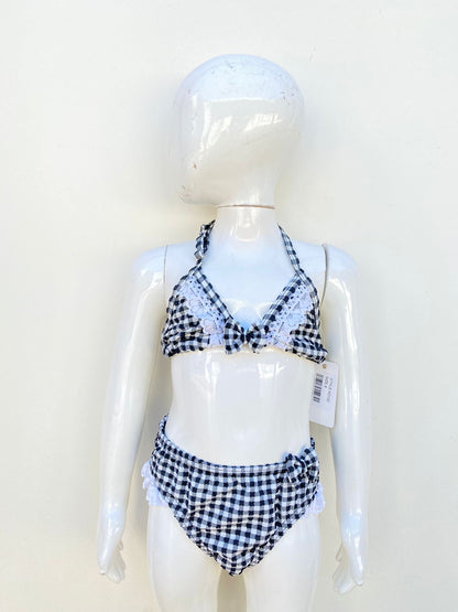 Biquini Traje de baño niñas Envya kids original, negro con cuadros en blanco y moño en blanco.