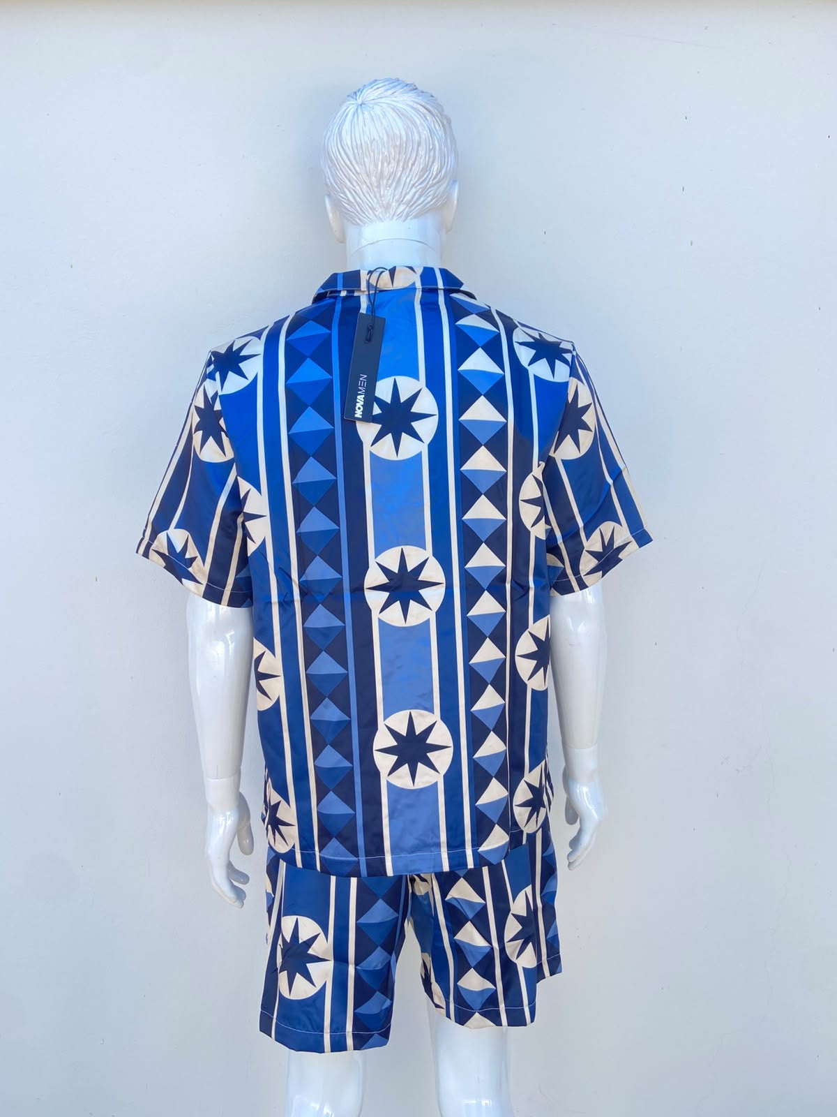 Conjunto, azul marino con estampado de figuras en color crema, de bermuda y camisa.