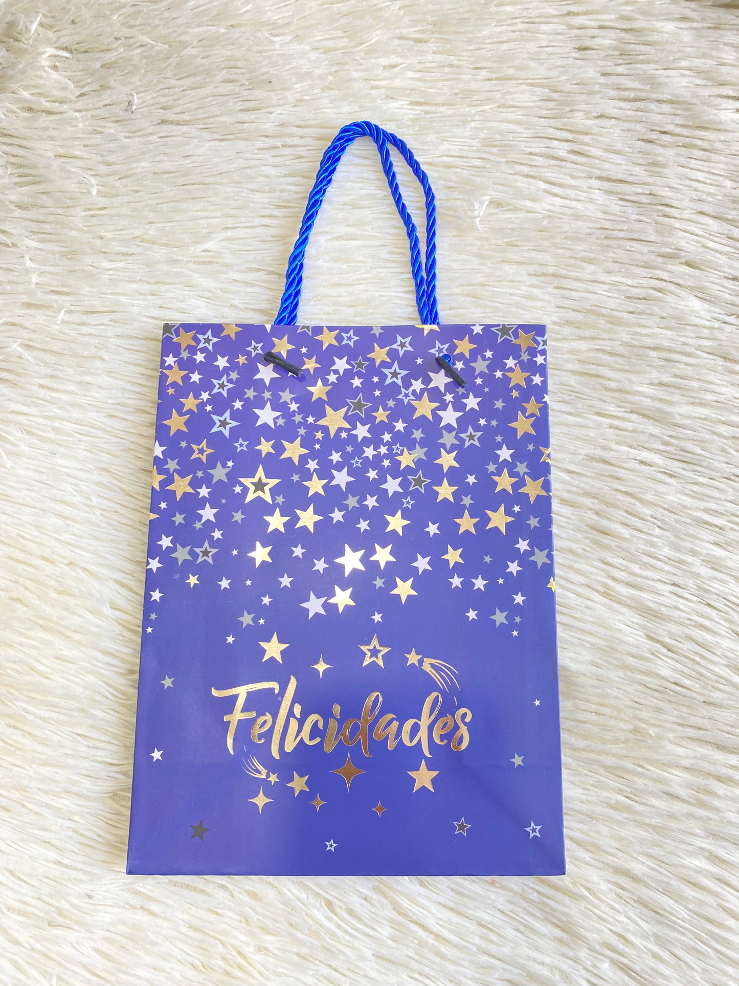 Shopping azul marino con estrellas doradas y letras felicidades debajo. PEQUEÑO