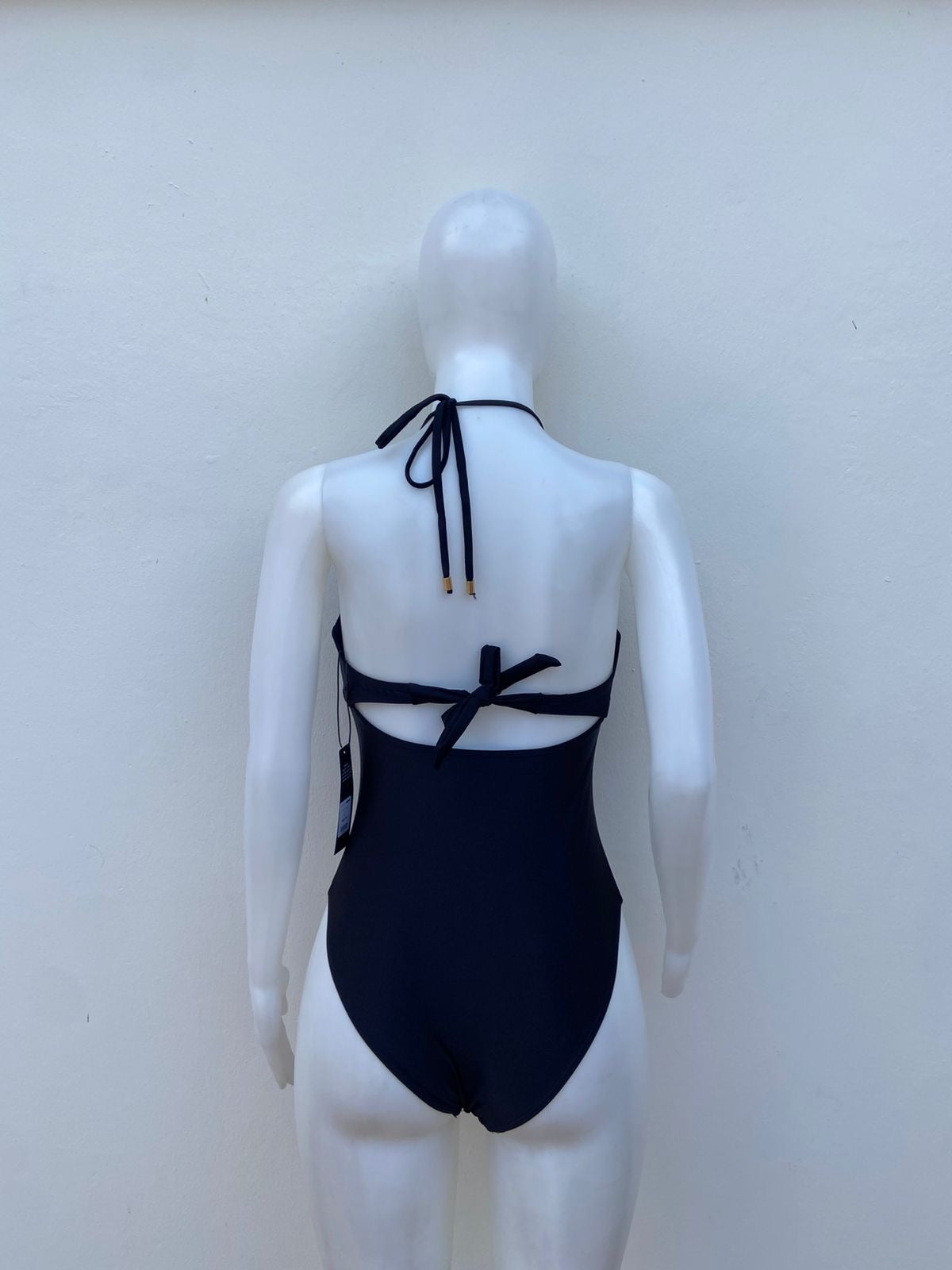 Biquini, negro liso con placa en medio en forma de corazón y lazos ajustables.