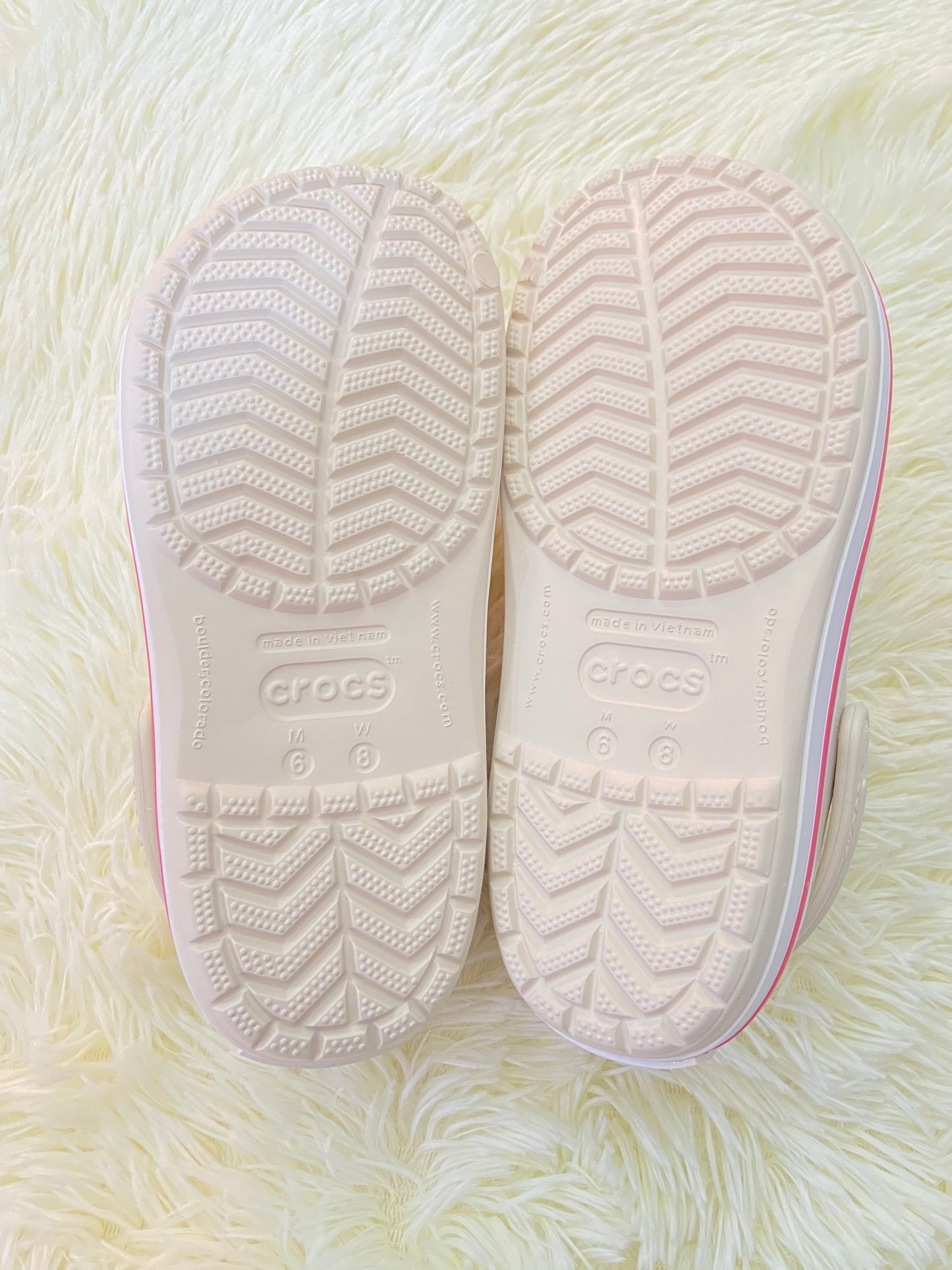 Sandalias CROCS original, crema con líneas rosadas y blancas.