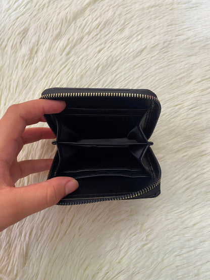 Monedero negro diseño acolchado, con cierre de zíper alrededor y super espacioso para tarjetas y más.