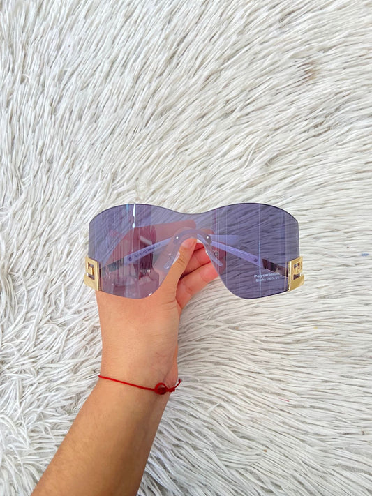 Lentes, negro con montura en color blanco y diseño de una G invertida dorada.