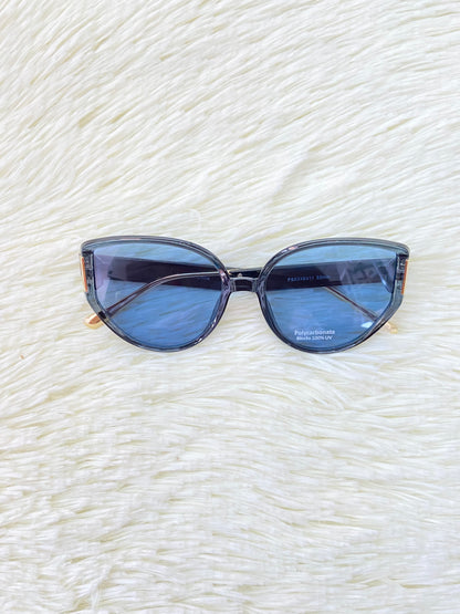 Lentes, negros con montura negra y dorada y micas de color azul, estilo gato, con protección UV 100% Polycarbonate.