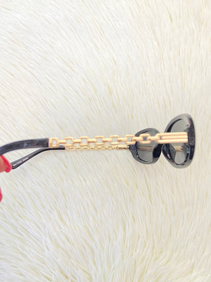 Lentes, negro con montura en estilo Cadena dorada y micas claras, ovalados, con protección UV 100-400