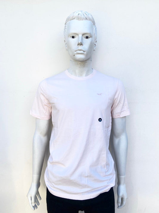 T-Shirt HOLLISTER Original en color rosado pastel con el logo de la marca arriba